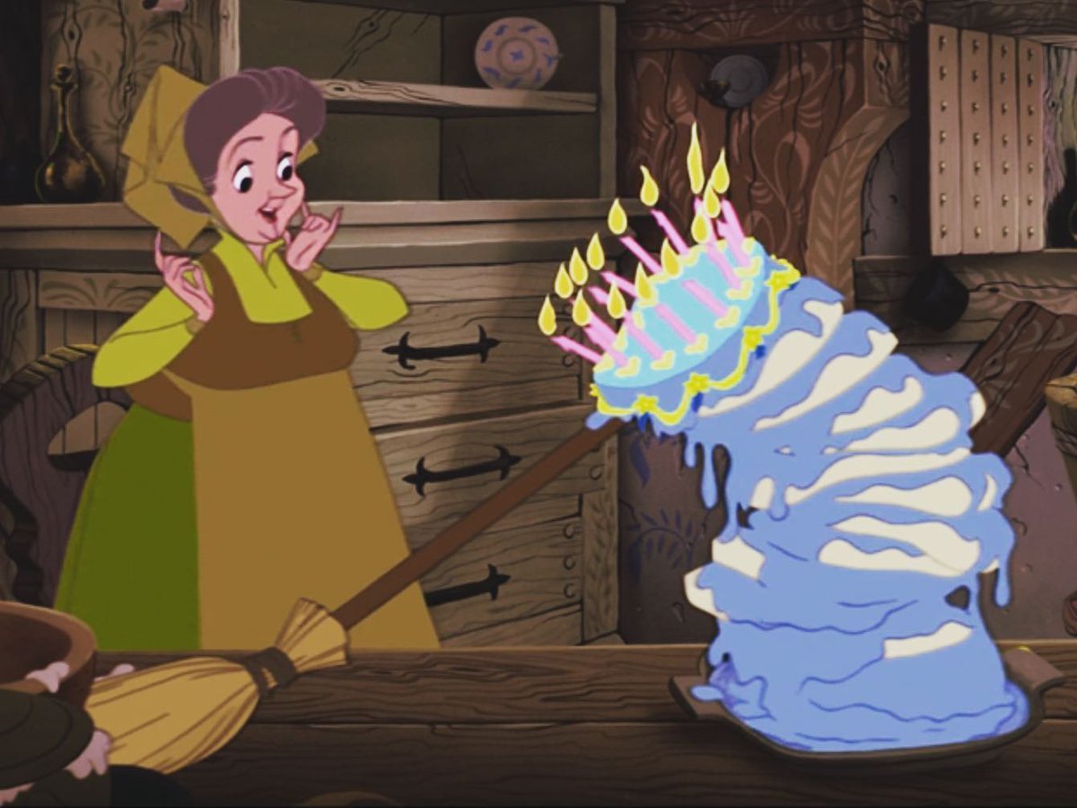 One of the fairies from Sleeping Beauty propping up her disaster of a cake with a broom.